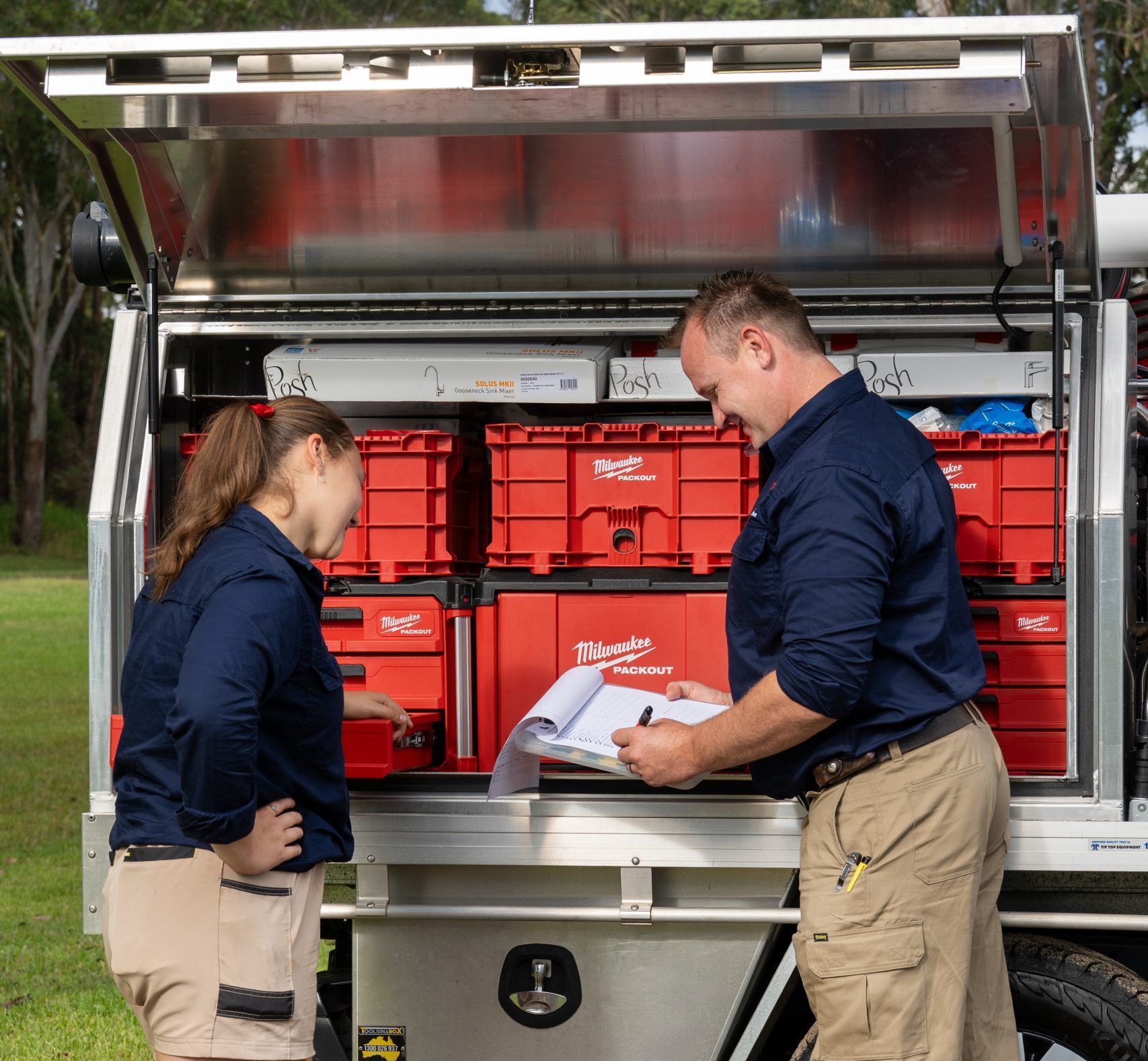 The Enjoy Plumbing team checking stock at the service vehicle